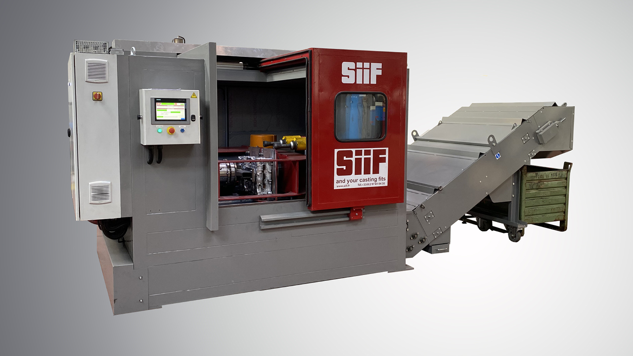 Decoring machine removing molding sand from a casting